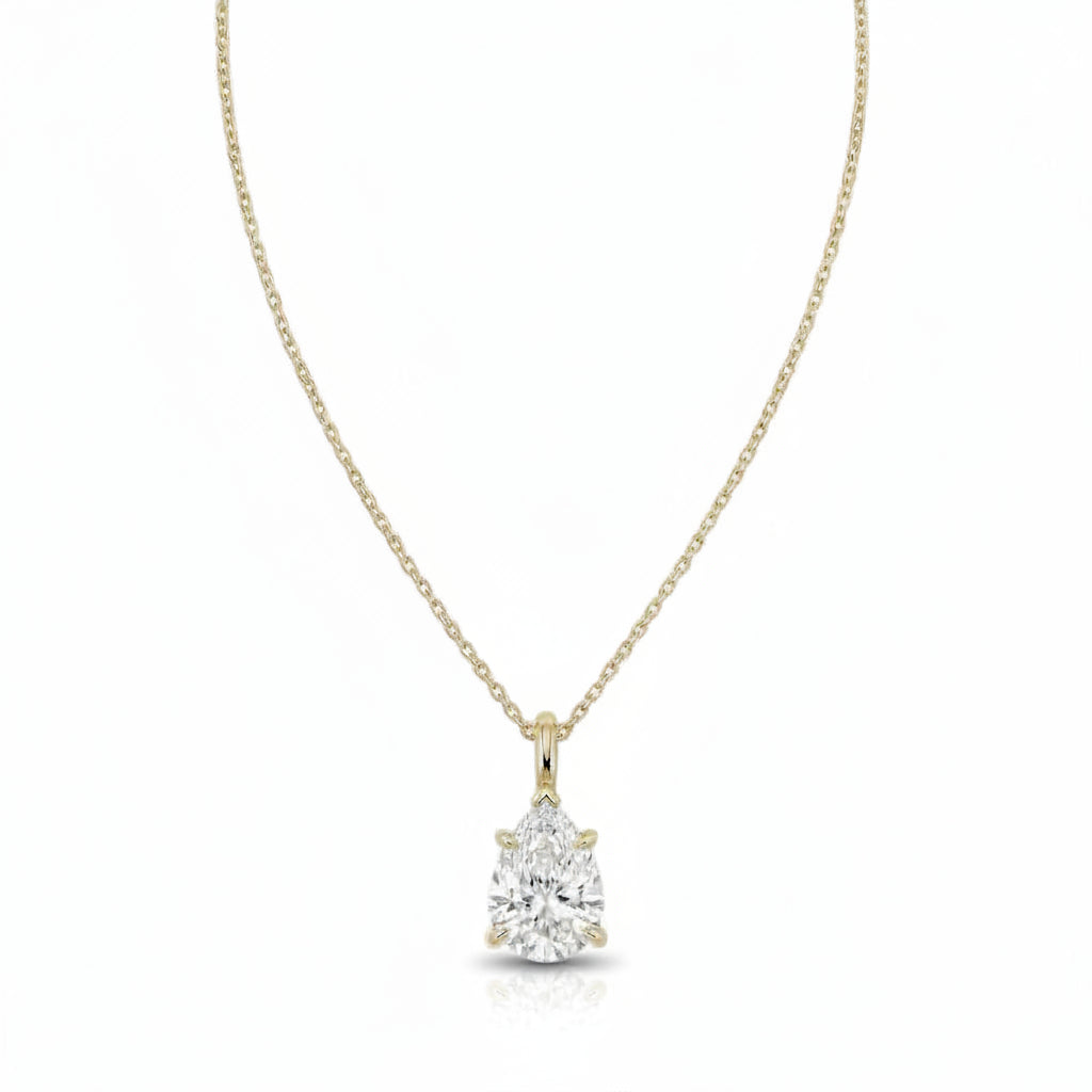 A yellow gold necklace with a single solitaire pear diamond pendant, displayed against a solid white background.