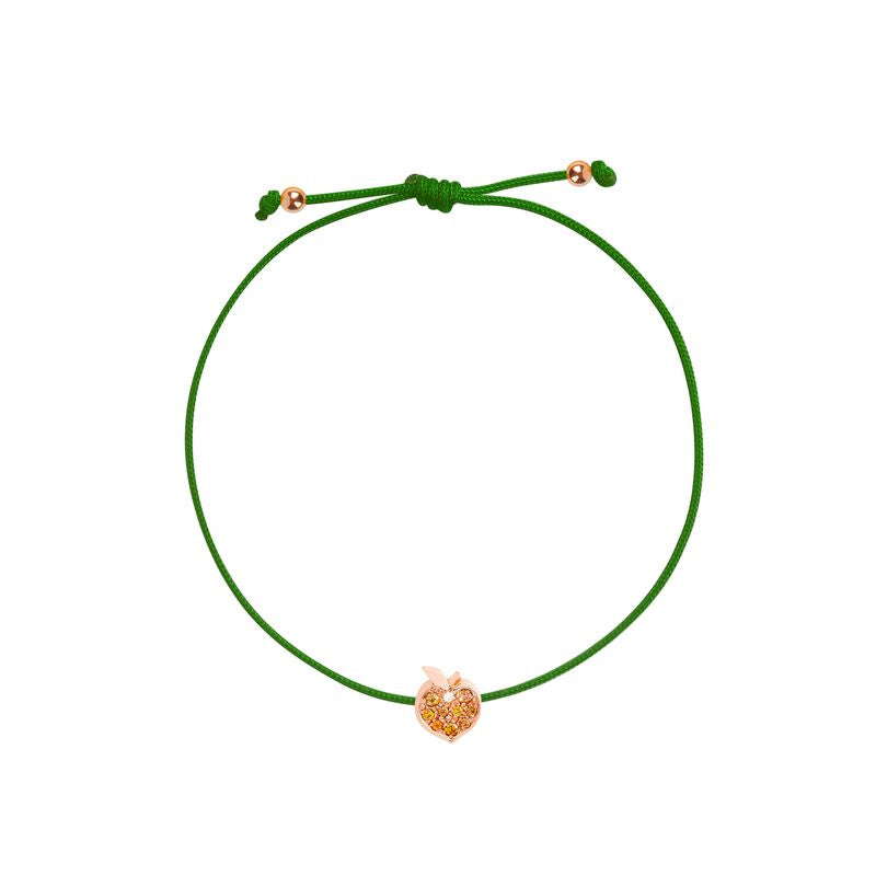 A green adjustable cord bracelet with a small rose gold apple-shaped charm in the center, displayed on a clean white background.