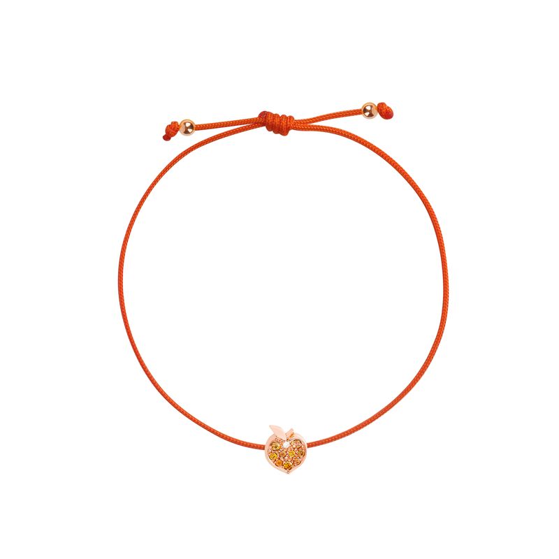 An orange adjustable cord bracelet with a small rose gold apple-shaped charm in the center, displayed on a clean white background.