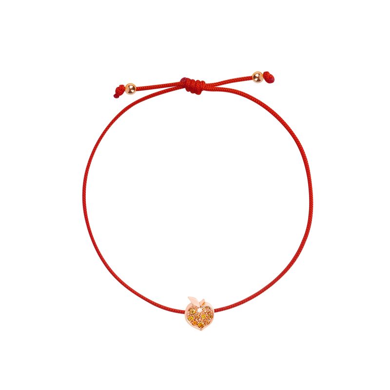 A red adjustable cord bracelet with a small rose gold apple-shaped charm in the center, displayed on a clean white background.