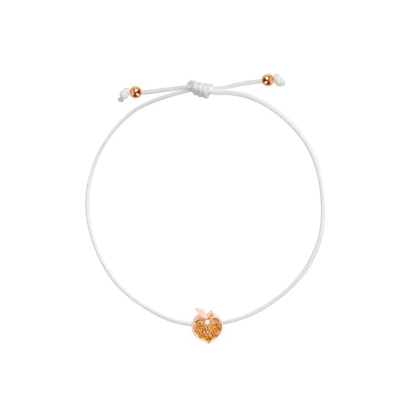 A white adjustable cord bracelet with a small rose gold apple-shaped charm in the center, displayed on a clean white background.