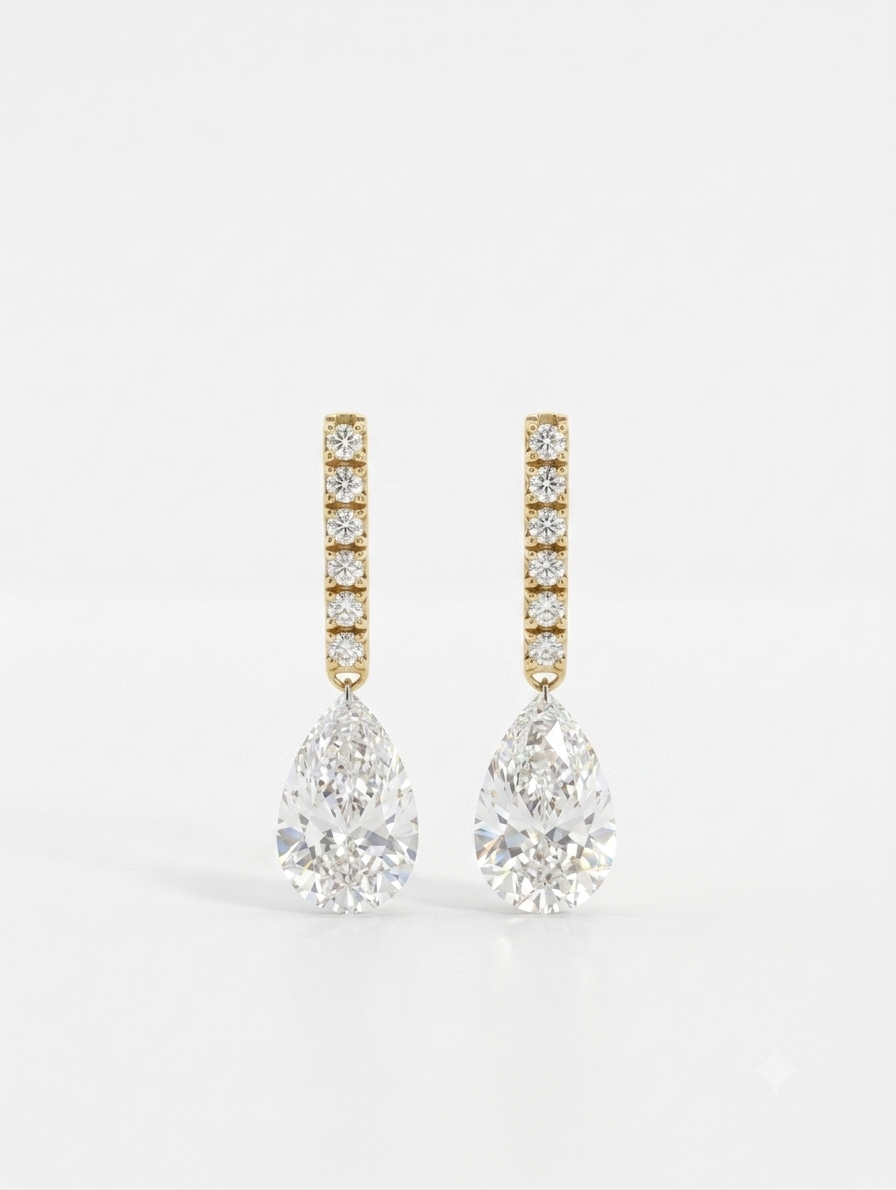 Inga Fine Jewelry Drilled Pear Diamond Drop Earrings in 18k Yellow Gold with Platinum Connector on the light gray background.