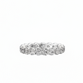 A diamond eternity ring in a silver-colored metal setting, featuring a continuous row of round brilliant-cut diamonds on a plain white background.