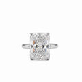 Platinum 5.06 carat radiant cut lab diamond solitaire engagement ring on 2mm band on a plain white background.