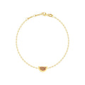 A delicate yellow gold chain bracelet with a small watermelon charm adorned with dark red gemstones, displayed on a clean white background.

