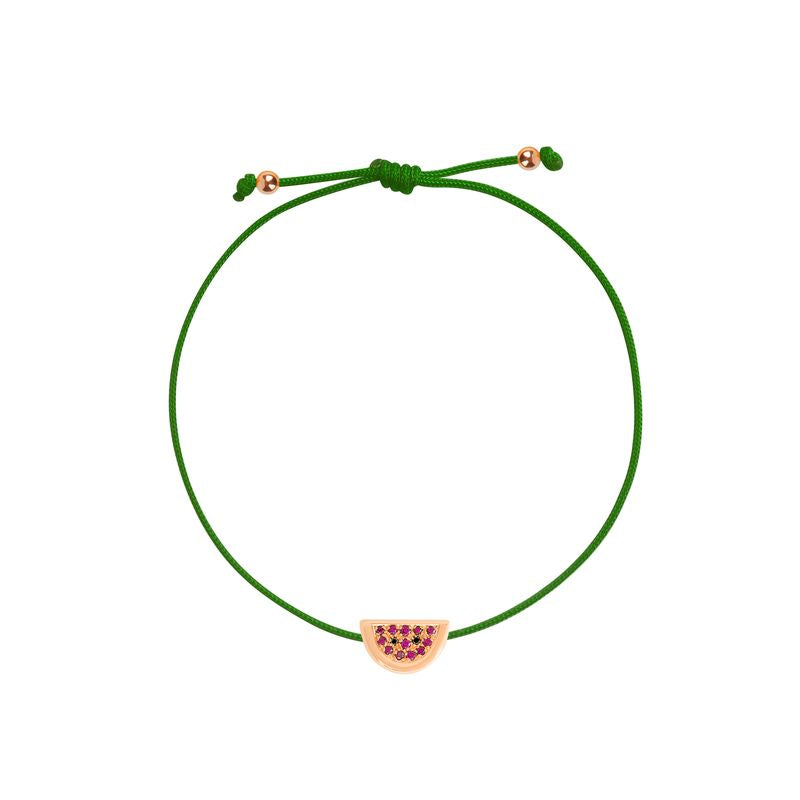 A green cord bracelet with a watermelon-themed charm featuring pinkish-red seeds and a gold-toned outline, shown on a plain white background.
