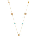 A delicate gold necklace featuring multiple small circular gold ornaments, some with tiny light blue stones and others with textured yellow center stones, displayed on a clean white background.