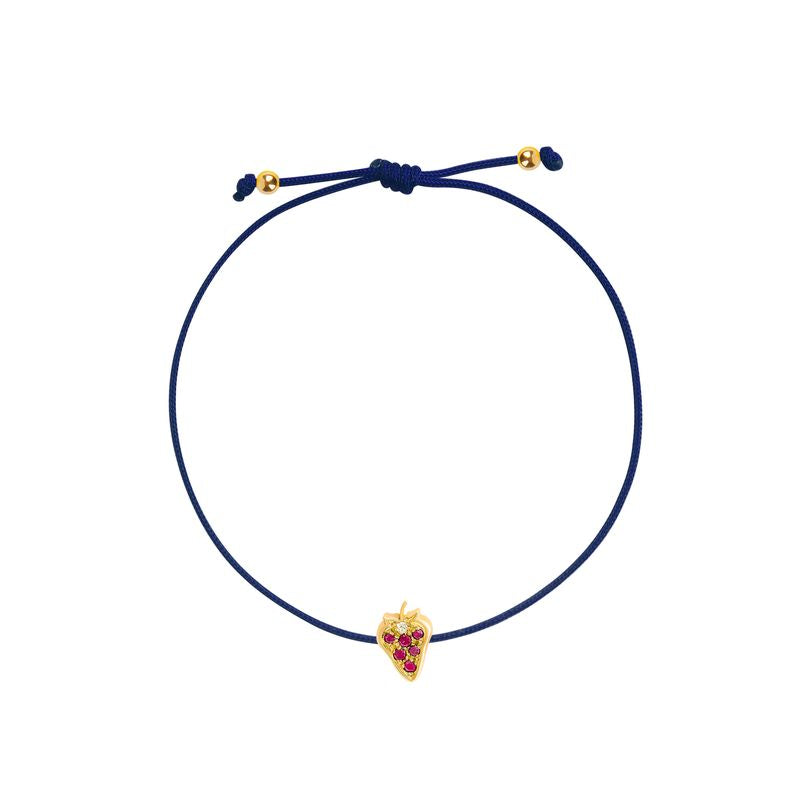 An adjustable navy blue cord bracelet featuring a small yellow gold strawberry charm embellished with red gemstones, displayed on a clean white background.