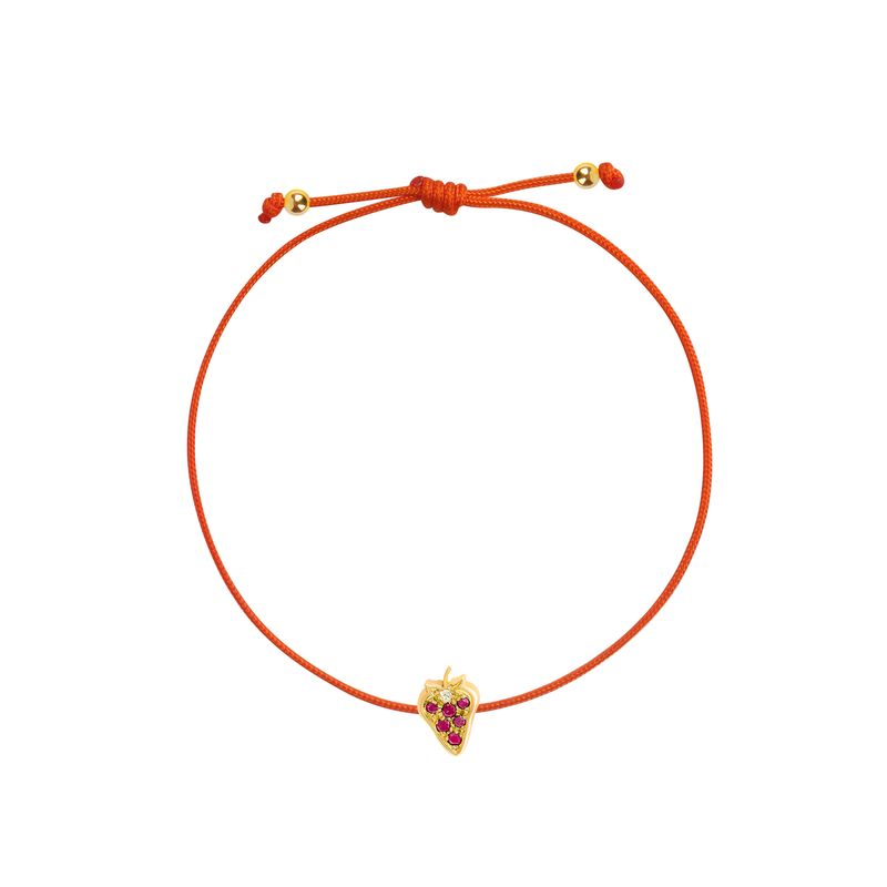 An adjustable orange cord bracelet featuring a small yellow gold strawberry charm embellished with red gemstones, displayed on a clean white background.
