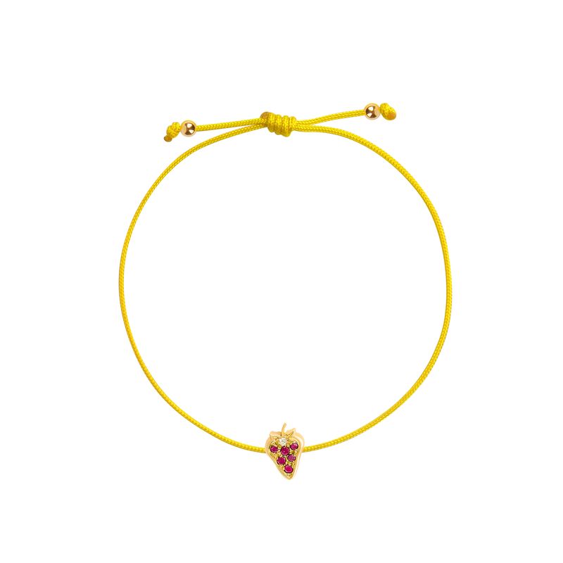 An adjustable yellow cord bracelet featuring a small yellow gold strawberry charm embellished with red gemstones, displayed on a clean white background.