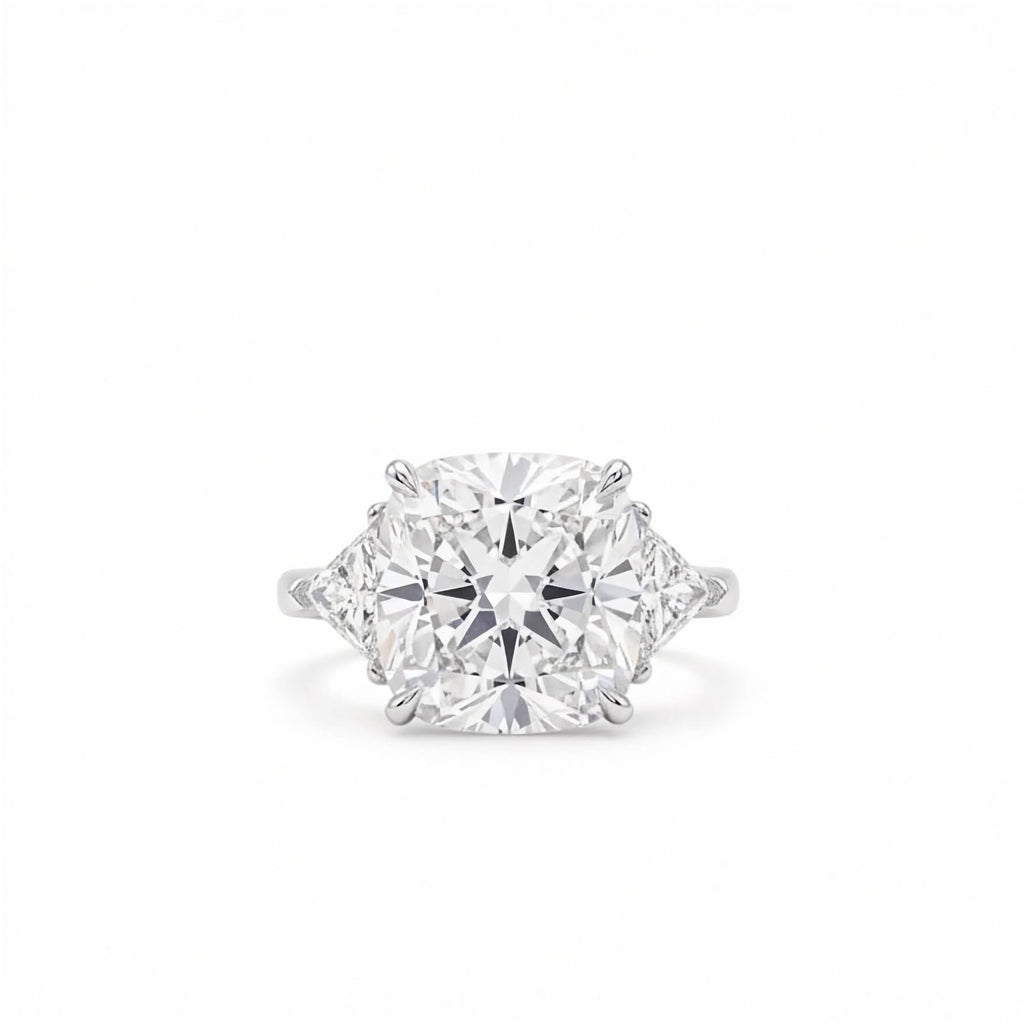 18k white gold three stone ring featuring 7 carat square cushion lab diamond flanked by trillion side stones on white backgorund.