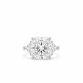 18k white gold three stone ring featuring 7 carat square cushion lab diamond flanked by trillion side stones on white backgorund.