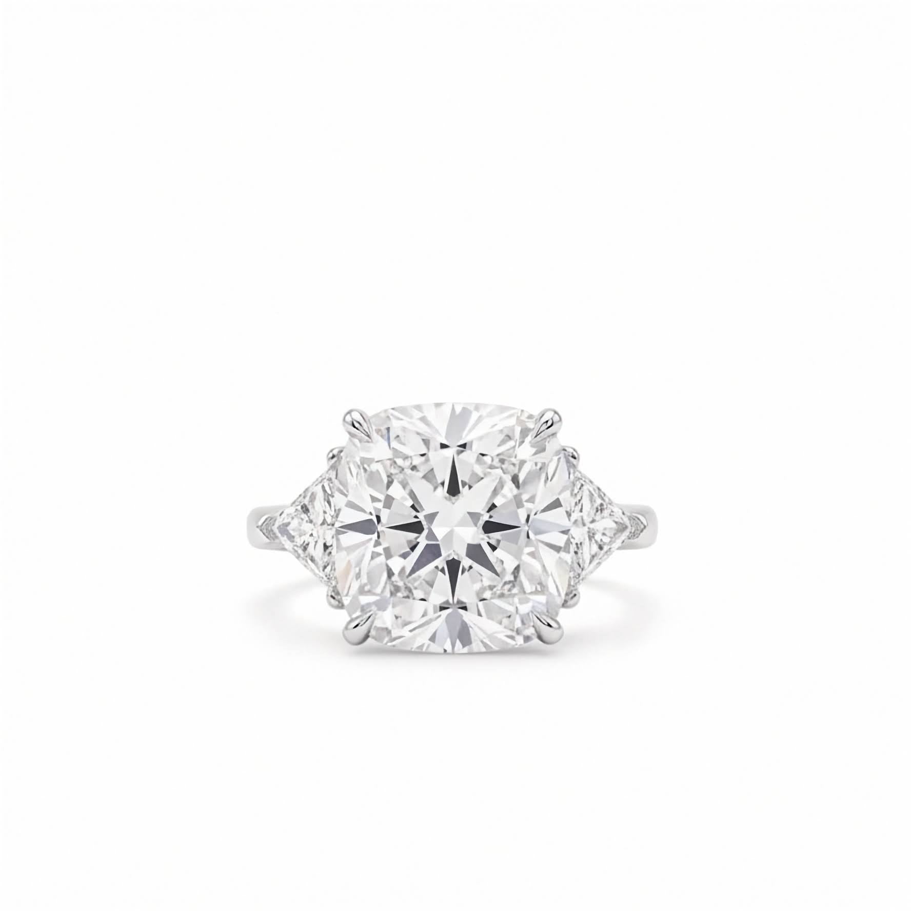 18k white gold three stone ring featuring 7 carat square cushion lab diamond flanked by trillion side stones on white backgorund.