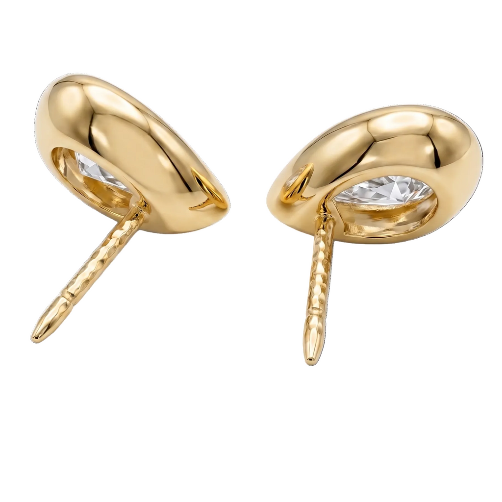 A pair of pear-shaped diamond bezel set stud earrings in yellow gold, shown from the back view against a plain white background.