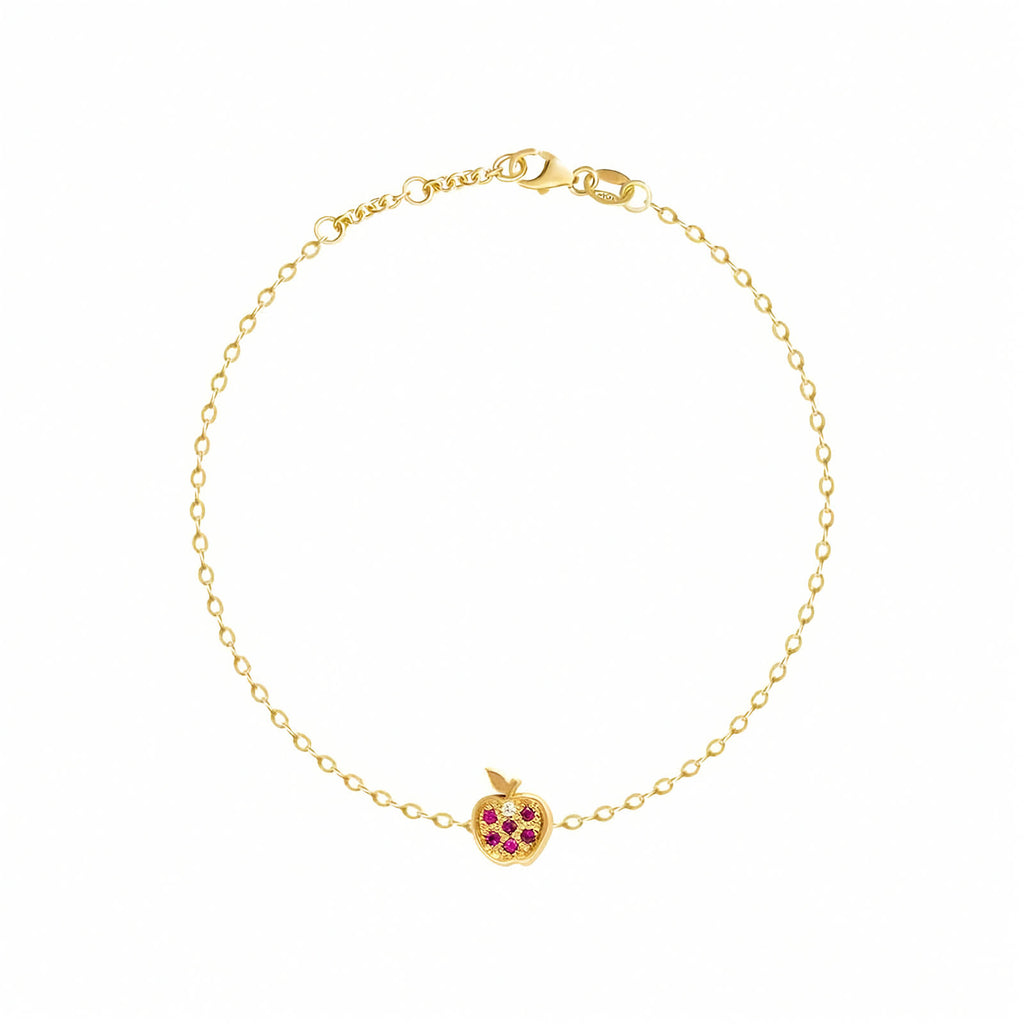 Rosmundo collaboration 18k gold apple chain bracelet with natural rubies and diamond. A delicate yellow gold chain bracelet with a small apple charm featuring red gemstone accents, displayed on a clean white background.