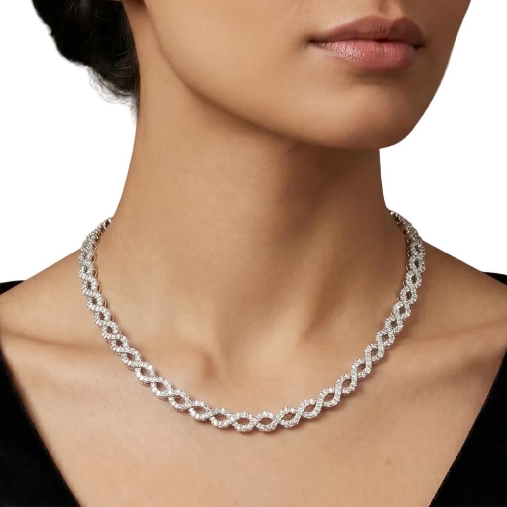 A gold chain necklace with a double row of sparkling clear pavé-set round diamonds in oval shaped design, displayed on a model.