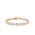 10.25 ctw mixed shape bezel set lab diamond tennis bracelet in 14k yellow gold with oval, marquise, and emerald cut diamonds on a white background. 