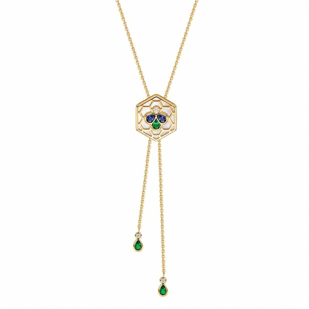 A yellow gold chain necklace with a hexagonal pendant featuring a Bee Icon 18k yellow gold charm with iolite, tsavorite, mother of pearl, and diamond shown on a plain white background.
