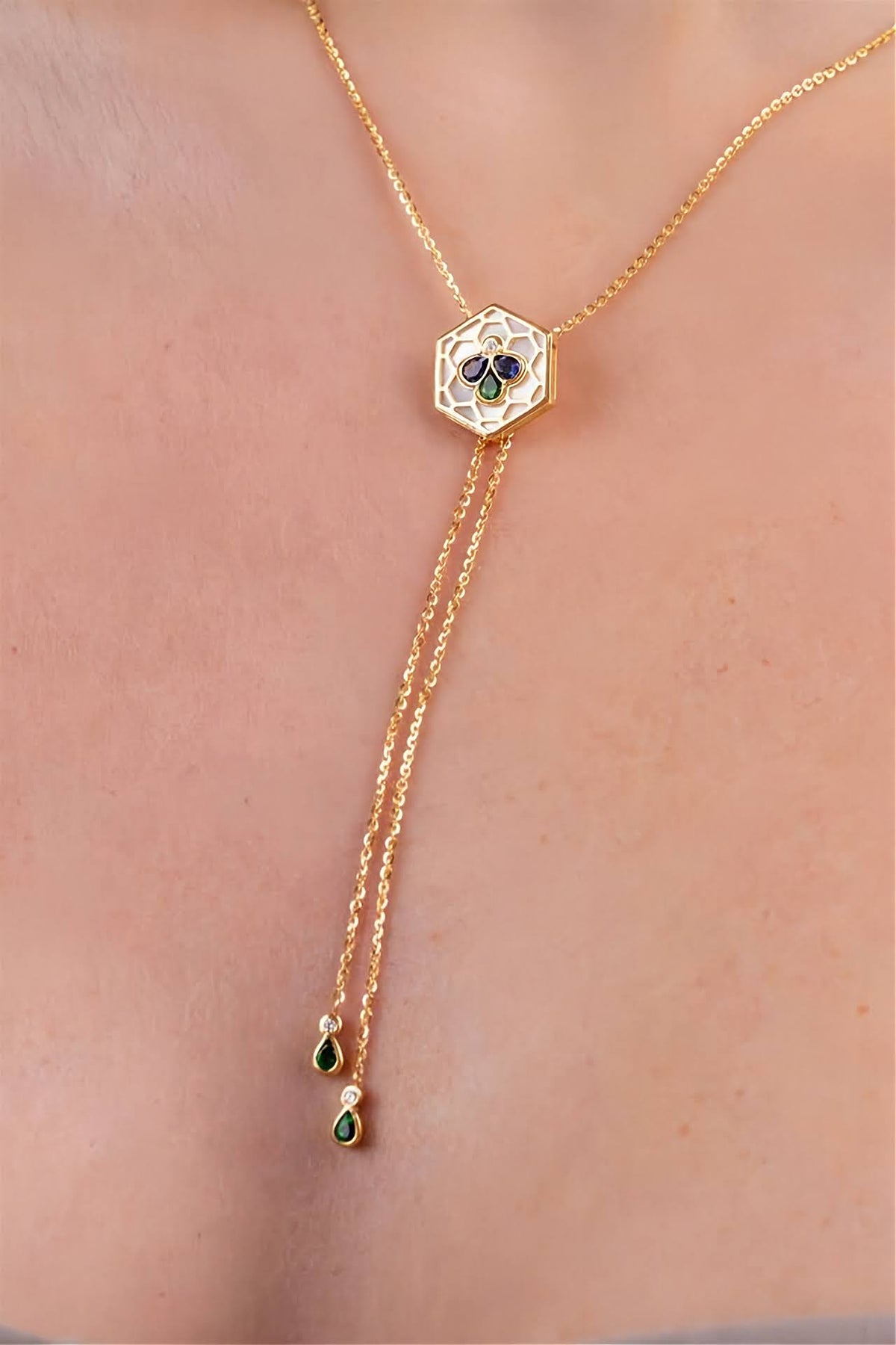 18k gold Bee Icon iolite and mother of pearl charm worn on chain shown on model.