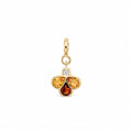 A gold charm pendant featuring three teardrop-shaped gemstones in yellow, orange, and amber-brown hues, with a small clear round-cut diamond at the top, set against a plain white background.