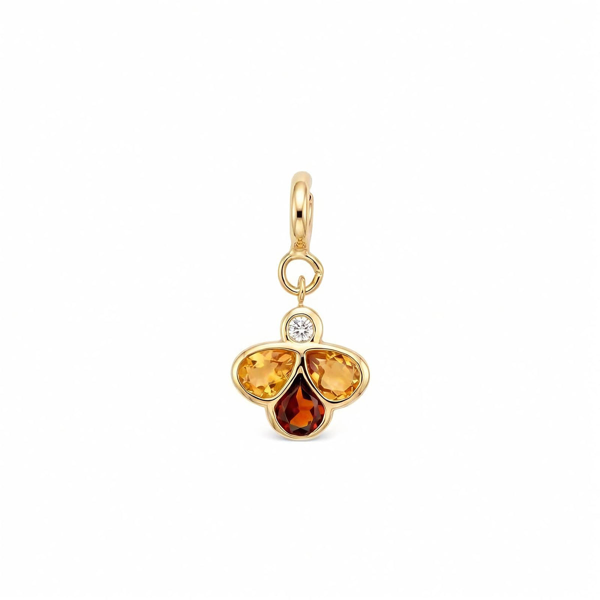 A gold charm pendant featuring three teardrop-shaped gemstones in yellow, orange, and amber-brown hues, with a small clear round-cut diamond at the top, set against a plain white background.