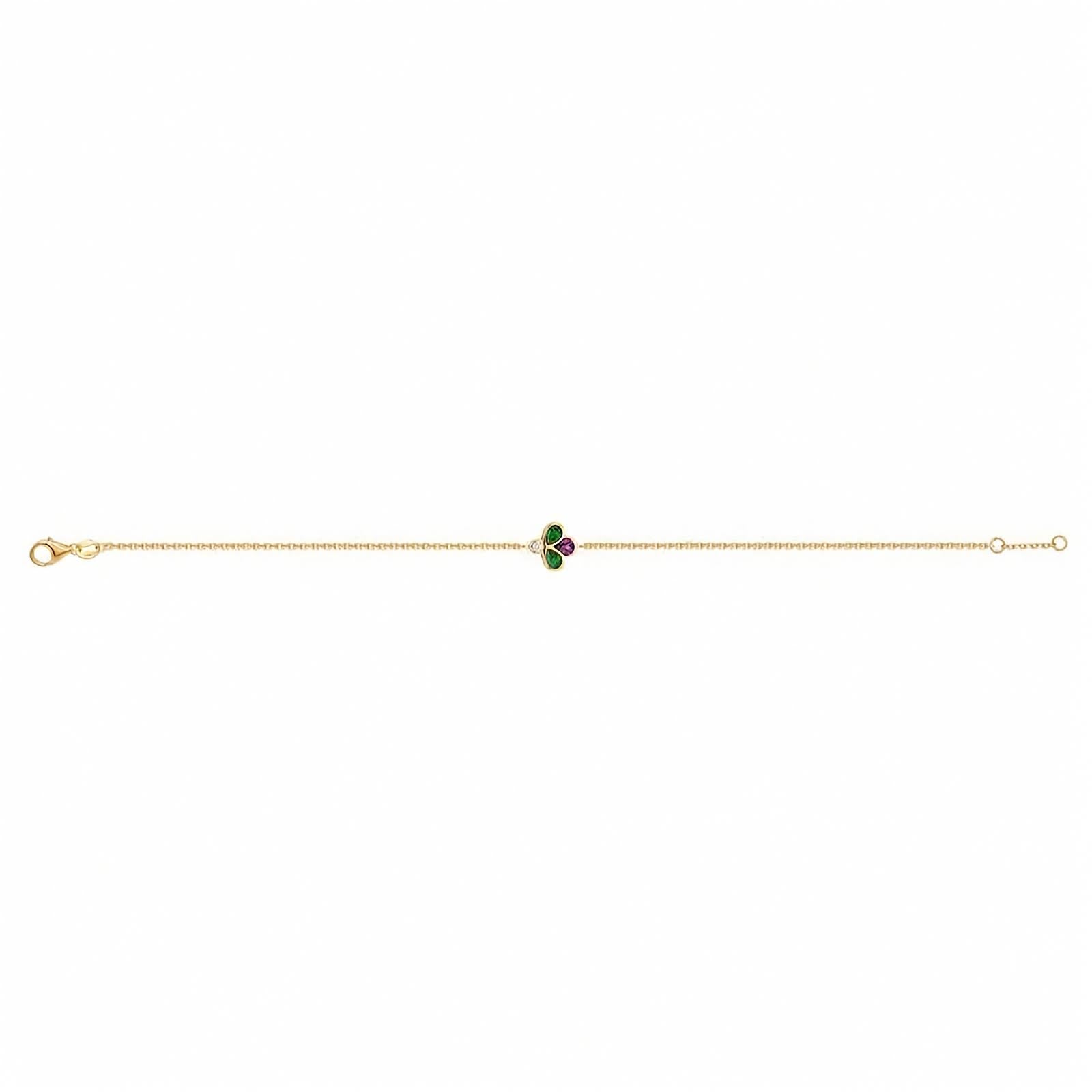A gold chain full lenght bracelet  featuring a central clover charm with green and purple stones, set against a plain white background.