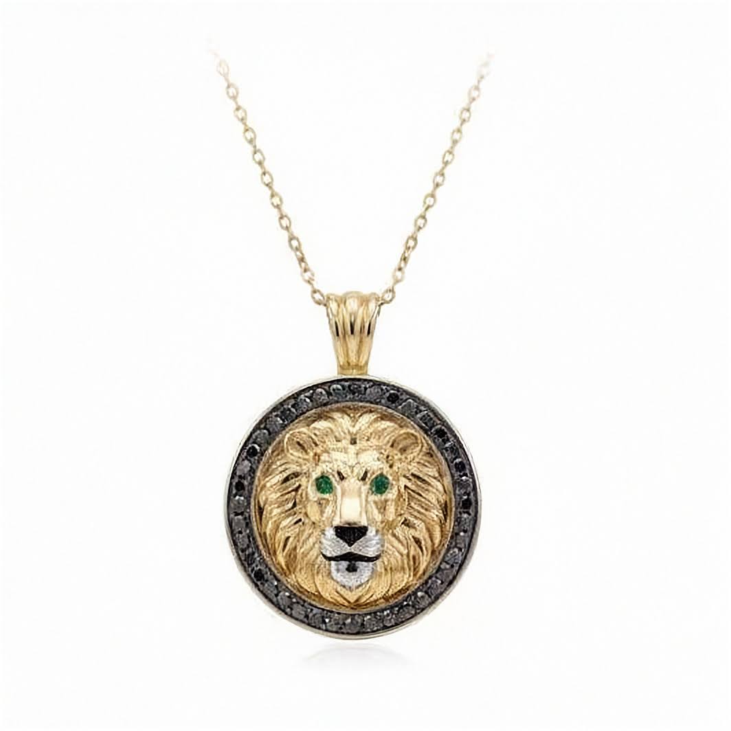 Inga Fine Jewelry Signature Gold Lion Pendant with Black Diamonds and Green Emerald Eyes shown on white background.