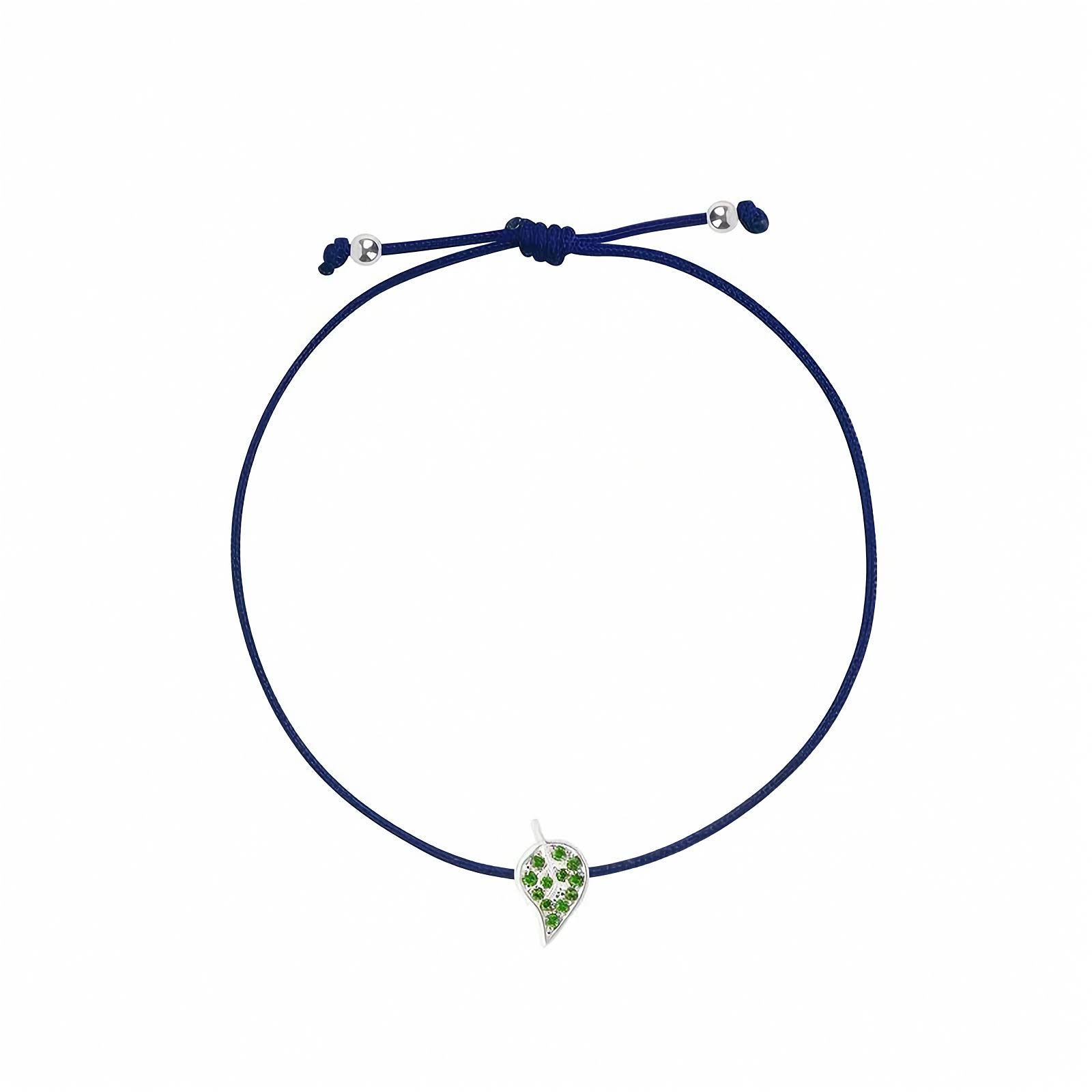 Rosmundo 18k White Gold Leaf String Bracelet with Natural Tsavorites. A navy blue cord bracelet featuring a small white gold leaf charm embellished with green stones, displayed on a clean white background.