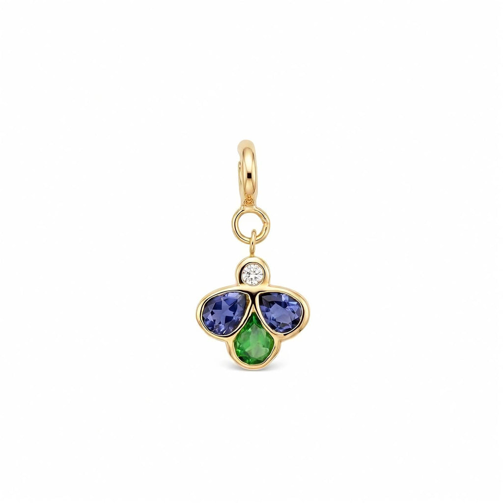 A yellow gold charm pendant featuring three flower-like stones in blue, green gemstones with a small clear round diamond above them, set against a plain white background.