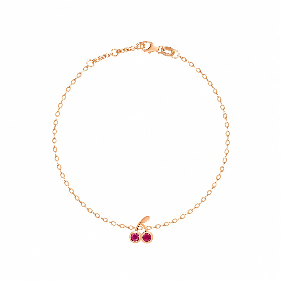 Rosmundo collaboration 18k gold cherry chain bracelet set with natural red rubies. A delicate rose gold chain bracelet with a cherry charm featuring two red gemstones and a small clear accent stone, displayed on a clean white background.