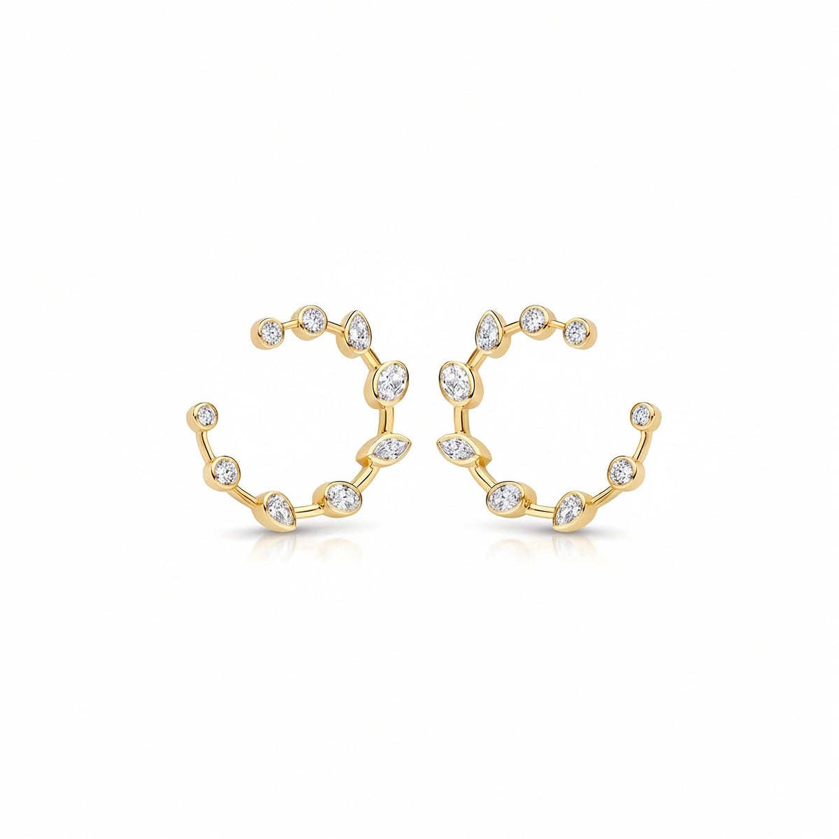 14k yellow gold bloom open c-hoop earrings set with 0.95 ctw multi-shape bezel-set lab diamonds. A pair of yellow gold stud design earrings with a wavy, branch-like design set with small clear marquise , oval and round diamonds, shown on a clean white background.