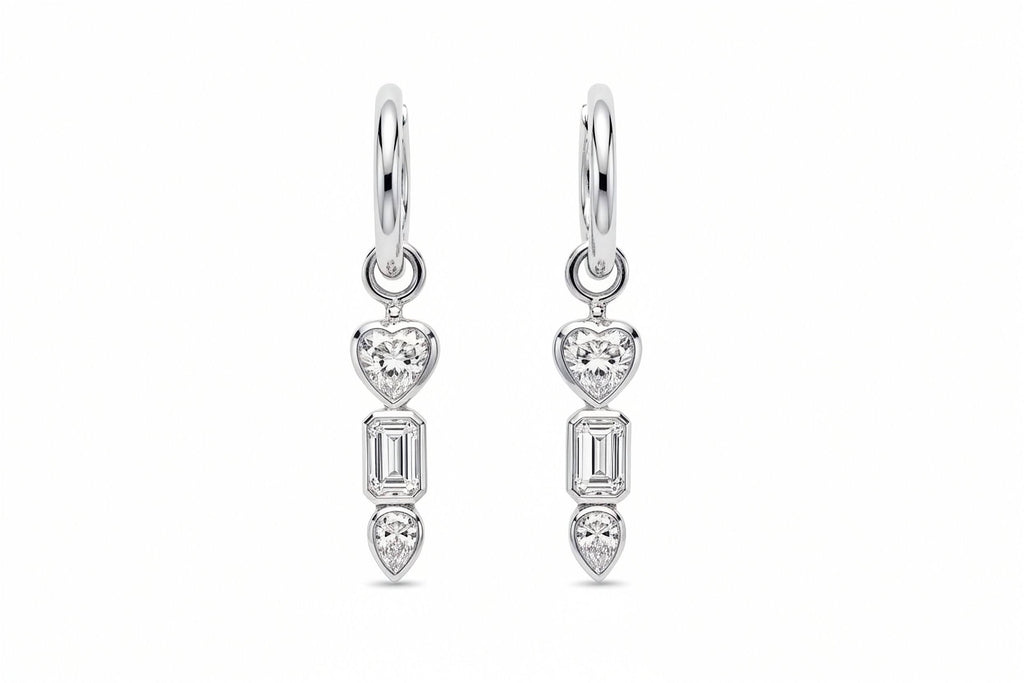 Inga Fine Jewelry 18k White Gold Romantic Geometry Lab Grown Diamond Earrings.White Gold bezel set drop earrings with heart and baguette cut and pear diamonds on a white background.