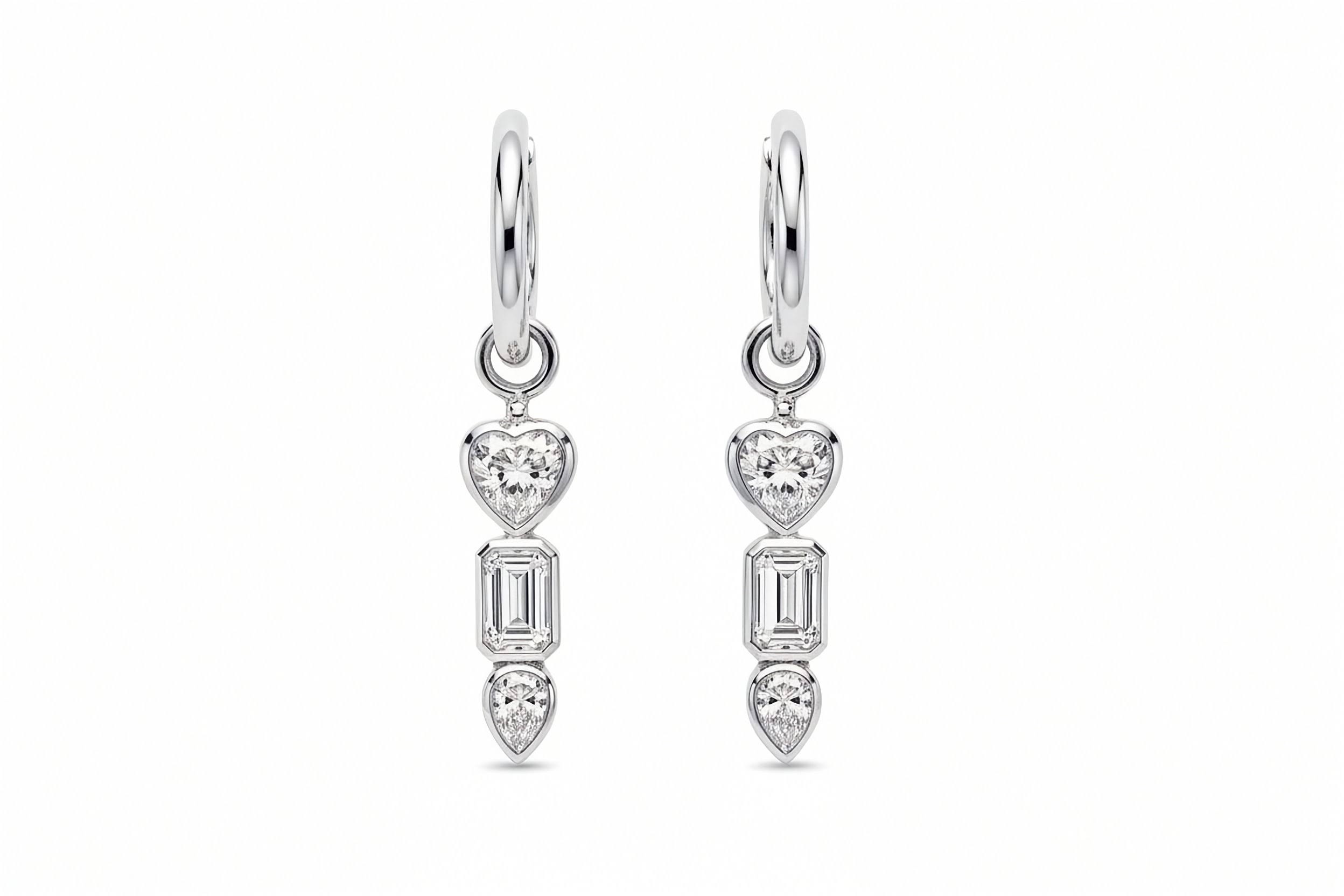 Inga Fine Jewelry 18k White Gold Romantic Geometry Lab Grown Diamond Earrings.White Gold bezel set drop earrings with heart and baguette cut and pear diamonds on a white background.