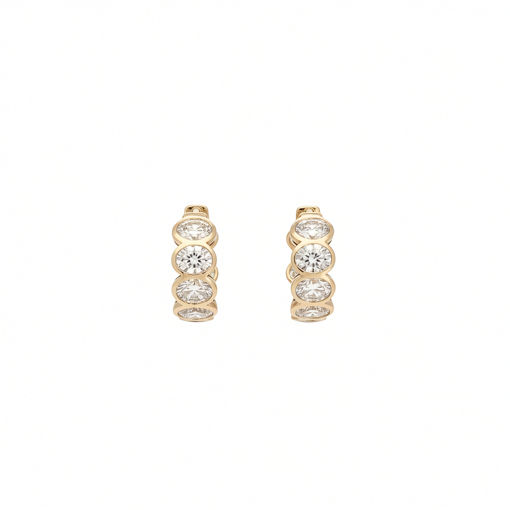 14K yellow gold bezel set oval lab grown diamond huggie hoop earrings 3.61 ctw front view Inga Fine Jewelry on white background.