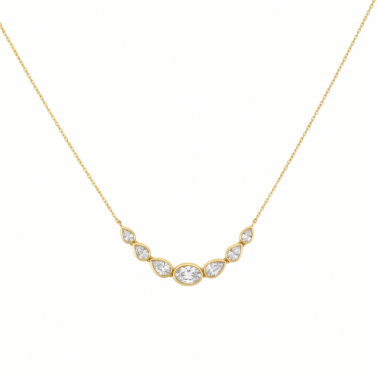 14K yellow gold curved bar necklace with center oval diamond and graduated pear diamonds by Inga Fine Jewelry on white background.