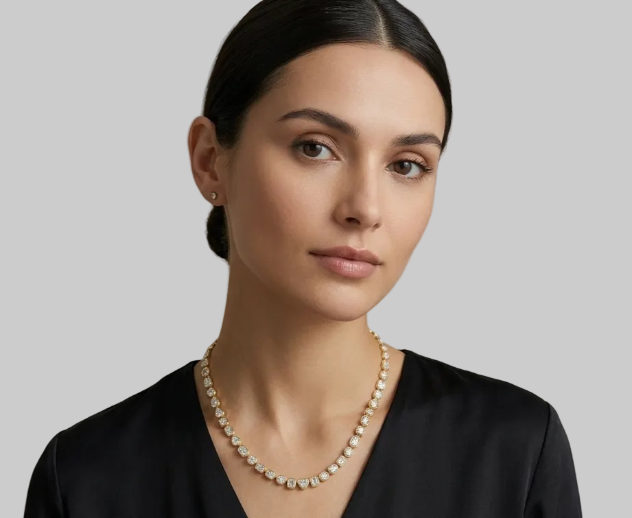 A yellow gold tennis necklace featuring multi-shaped diamonds in bezel settings, arranged in a circular shape on a model.
