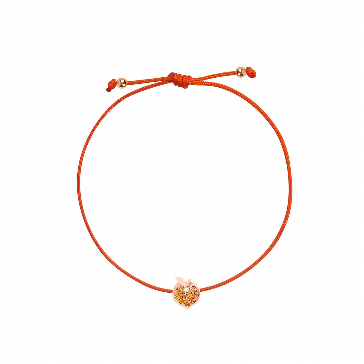 The Peach String Bracelet in 18k Rose Gold, Orange Sapphires & Diamond | Rosmundo. An orange adjustable cord bracelet with a small rose gold apple-shaped charm in the center, displayed on a clean white background.