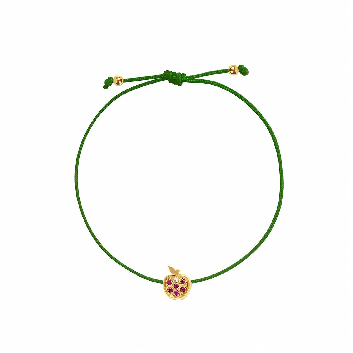 Rosmundo collaboration 18k yellow gold apple string bracelet with natural rubies and diamond on adjustable macrame cord. A green adjustable cord bracelet featuring a small yellow gold apple charm embellished with purple gemstones, set against a plain white background.