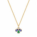 A gold chain necklace with a small clover-shaped pendant featuring a central round diamond, a two blue gemstones, and a bottom green teardrop gemstone, shown on a plain white background.