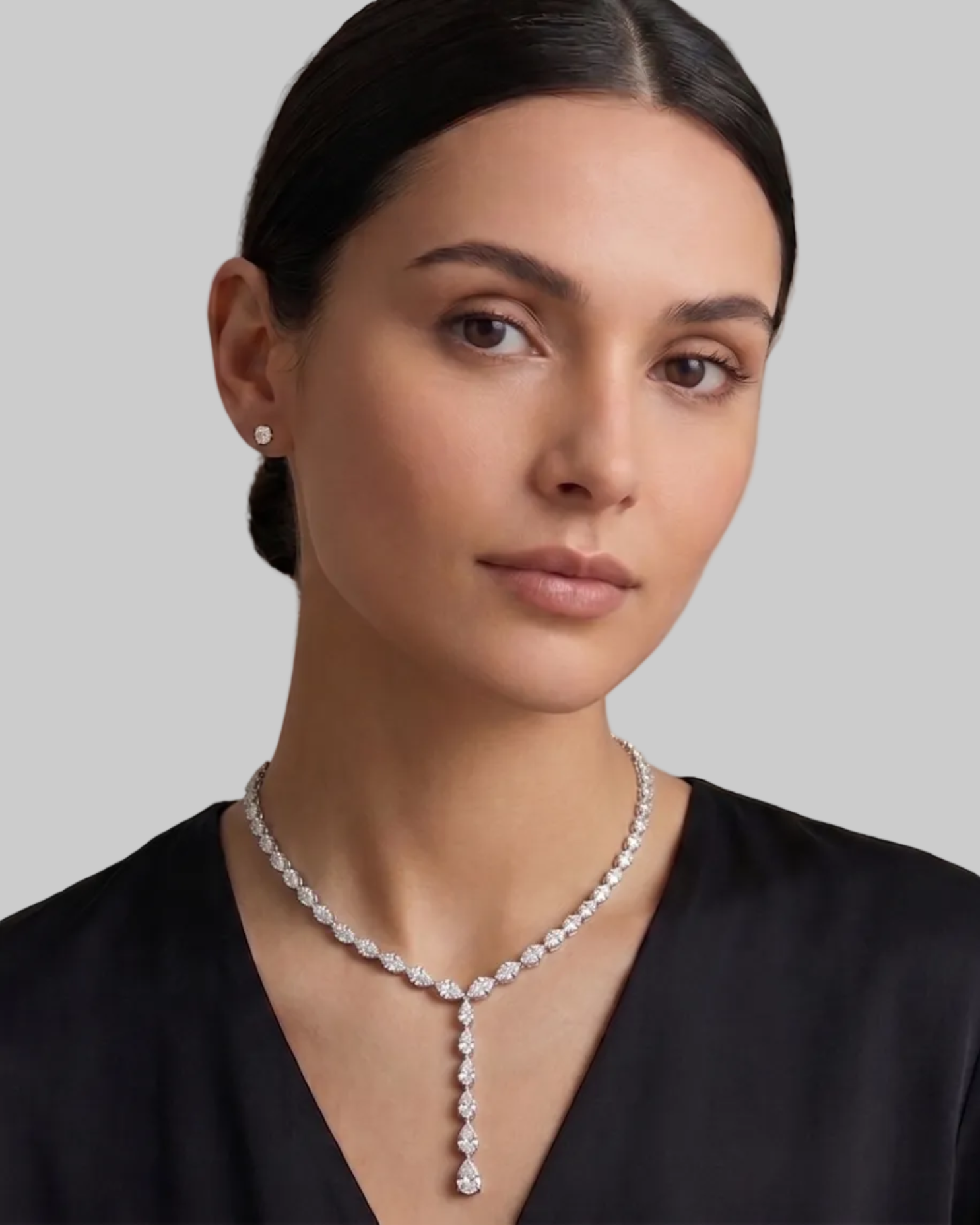 White Gold necklace with small pear prong set diamonds on a model.