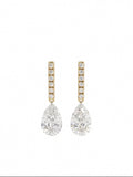 A pair of gold drop earrings featuring a vertical bar of small round-cut diamonds above a large pear-cut diamond drop, set against a clean white background.