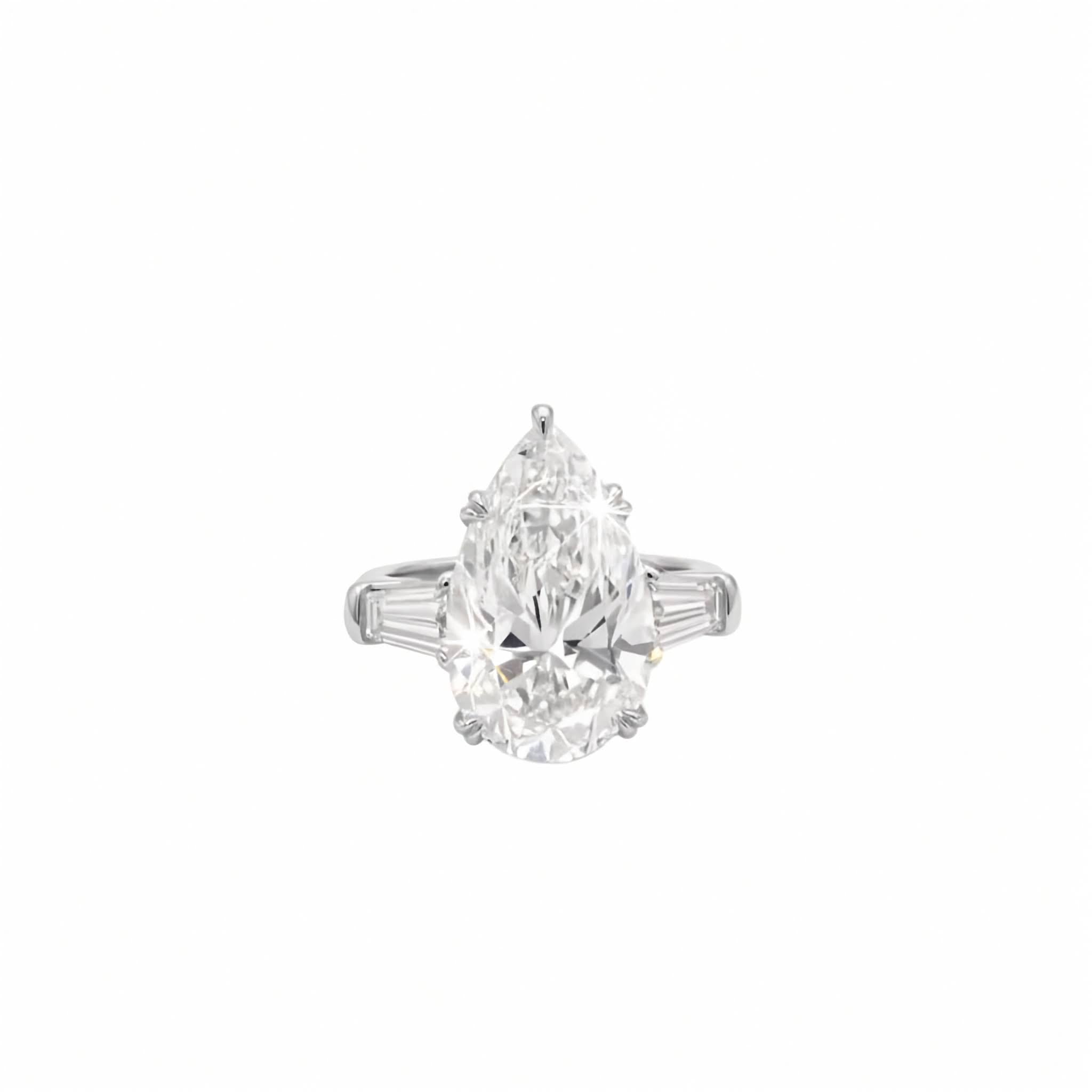 Platinum three-stone ring featuring 6 carat pear lab diamond flanked by tapered baguette side stones on a plain white background.