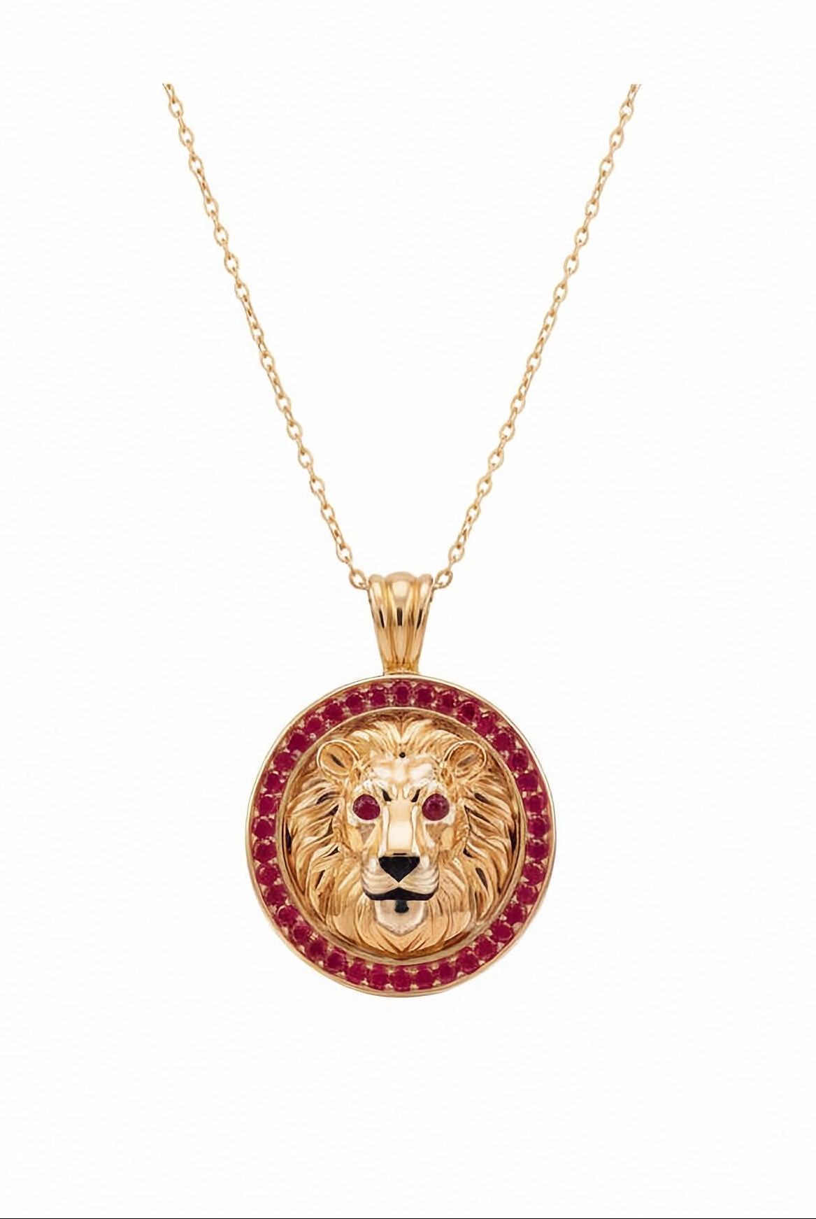 Inga Fine Jewelry Signature Gold Lion Pendant with Lab Grown Red Rubies. A gold lion head pendant necklace on a delicate gold chain, featuring a border of red ruby gemstones around the lion's mane and ruby-red eyes, set against a plain white background.