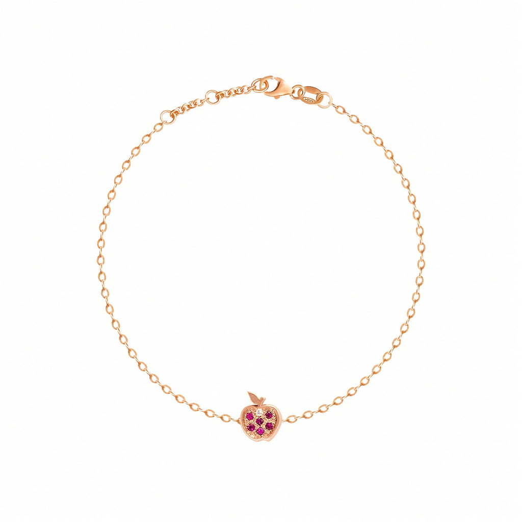 Rosmundo collaboration 18k rose gold apple chain bracelet with natural rubies and diamond. A delicate rose gold chain bracelet with a small apple charm featuring pink gemstone accents, displayed on a clean white background.