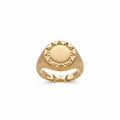 A yellow gold signet ring with a circular sunburst design on the face, featuring a brushed center and small cutout details around the border, shown on a plain white background.