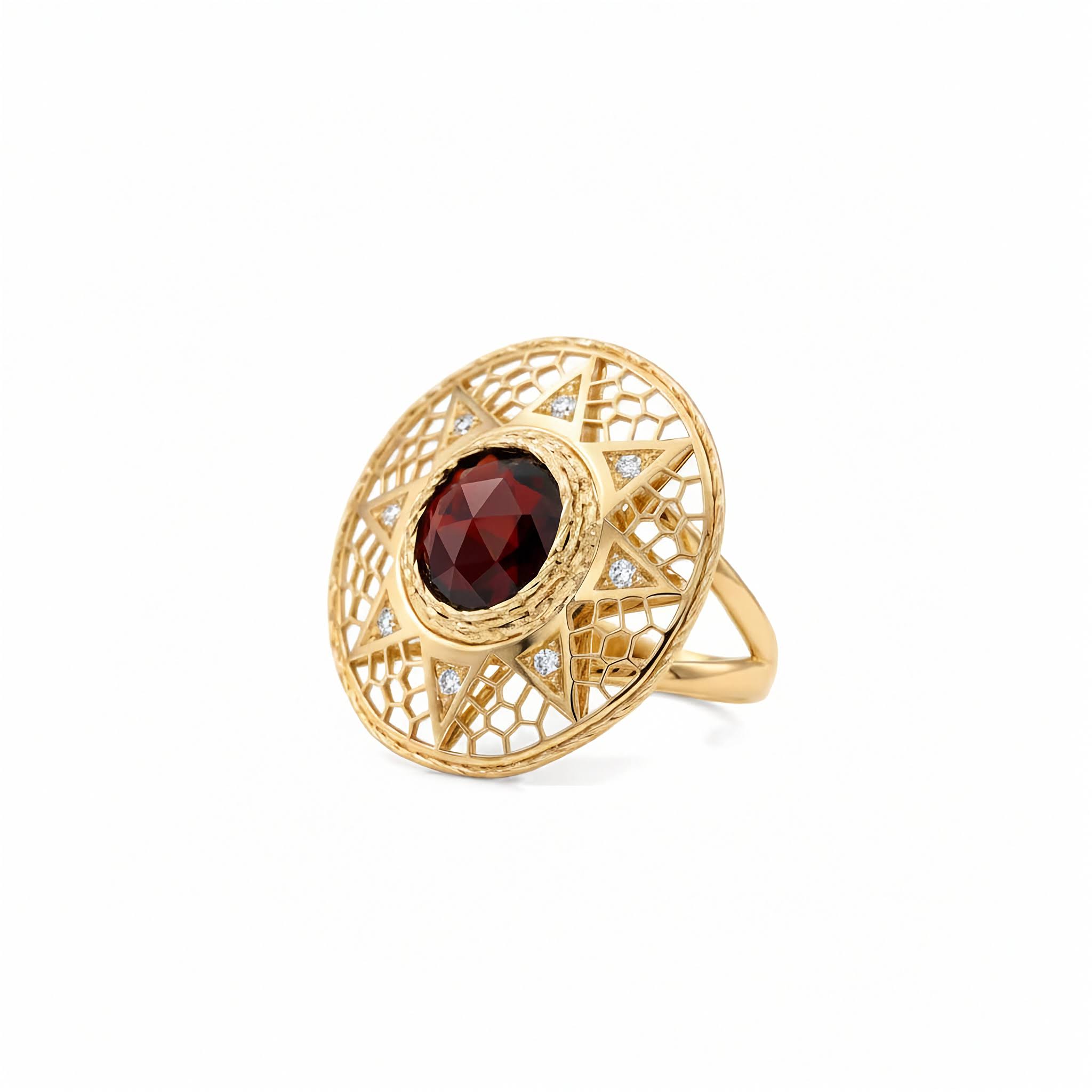 A gold filigree ring featuring a large round  faceted dark red garnet in the center, with small clear stones set along the inner circular frame, shown on a plain white background.