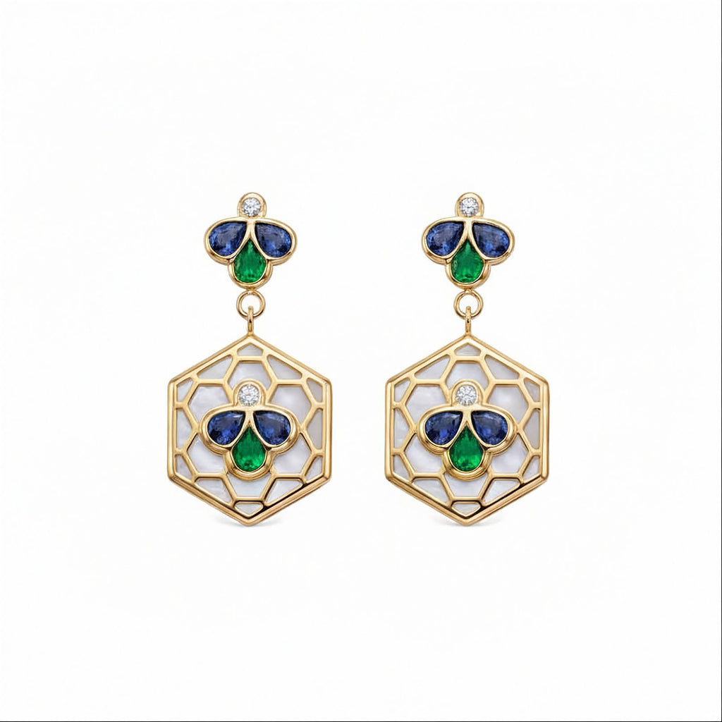 A pair of gold drop earrings featuring a hexagonal openwork design with white inlay, accented by blue and green enamel-like sections and a small round diamond at the top.
