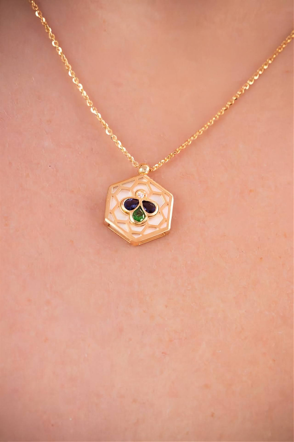 18k gold Bee Icon iolite and mother of pearl pendant necklace worn on model.