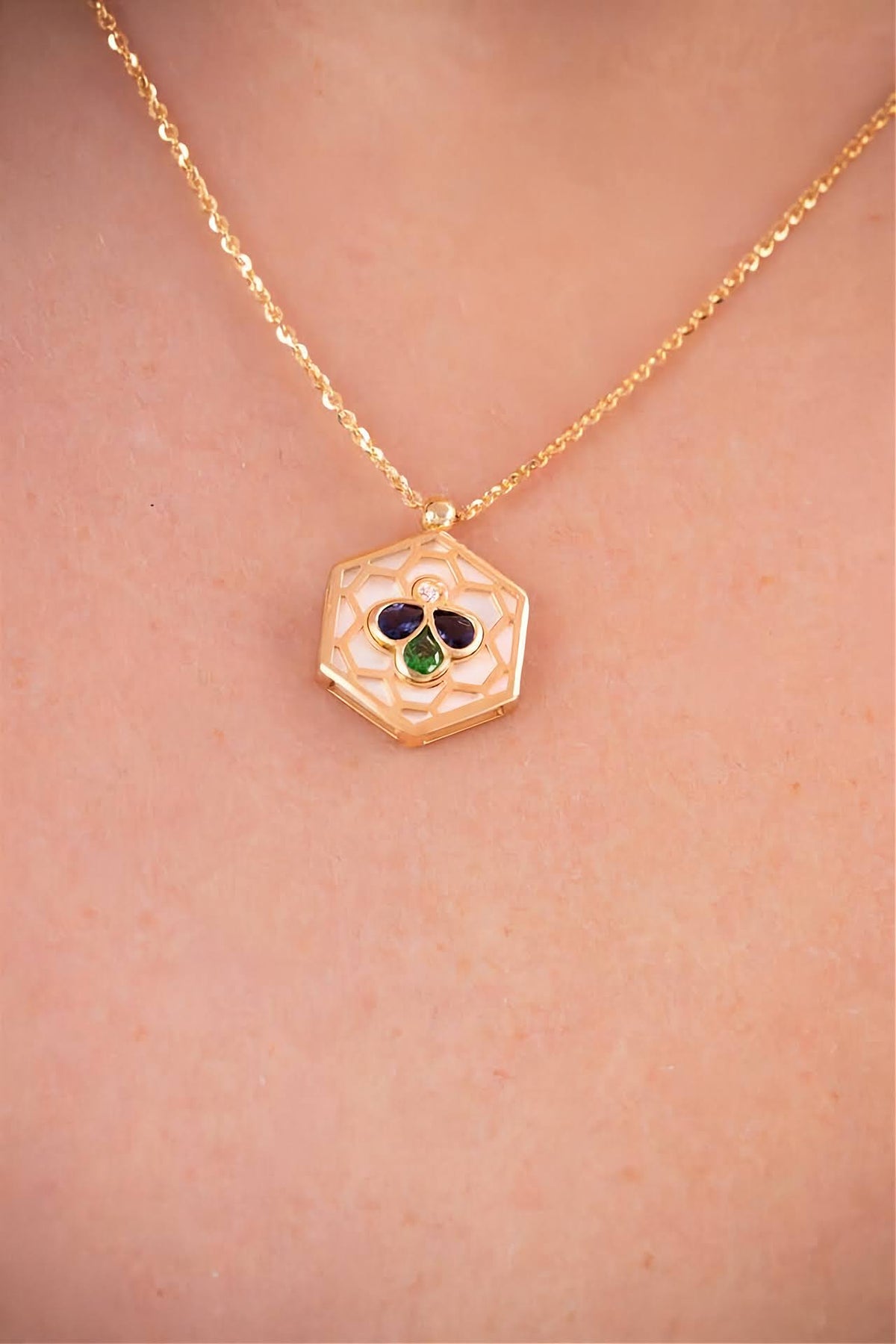 18k gold Bee Icon iolite and mother of pearl pendant necklace worn on model.