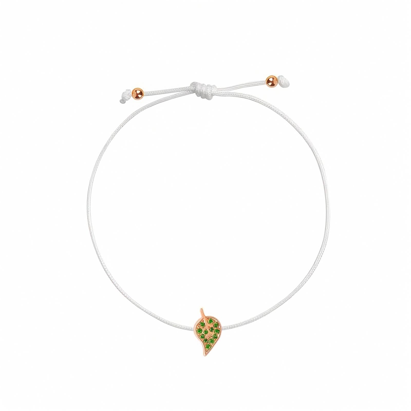 Rosmundo collaboration 18k rose gold leaf string bracelet with natural green tsavorites on adjustable macrame cord. A delicate white cord bracelet featuring a small leaf- shaped charm with green stones and a rose gold border, displayed on a clean white background.